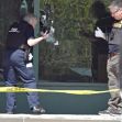 Investigation scene outside Old National Bank, showing law enforcement examining shattered windows following the mass shooting incident. Investigation scene outside Old National Bank, showing law enforcement examining shattered windows following the mass shooting incident.