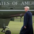 A person walking near a helicopter with the words "United States of America" visible. A person walking near a helicopter with the words "United States of America" visible.