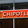 Chipotle restaurant sign with the logo displayed prominently. Chipotle restaurant sign with the logo displayed prominently.