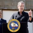 Governor Gavin Newsom speaking at a podium with the California state seal, addressing the media during a press conference. Governor Gavin Newsom speaking at a podium with the California state seal, addressing the media during a press conference.
