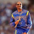 Snoop Dogg performing on stage at an event, dressed in a blue outfit with sunglasses and holding a microphone. Snoop Dogg performing on stage at an event, dressed in a blue outfit with sunglasses and holding a microphone.