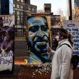 Hennepin County Judge Peter Cahill sent potential jurors in Derek Chauvin's trial home on Monday. Here, a painting of Floyd is seen outside the Hennepin County Government Center, where the trial is taking place. (Chandan Khanna/AFP via Getty Images)