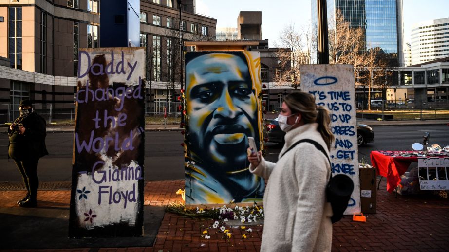 Hennepin County Judge Peter Cahill sent potential jurors in Derek Chauvin's trial home on Monday. Here, a painting of Floyd is seen outside the Hennepin County Government Center, where the trial is taking place. (Chandan Khanna/AFP via Getty Images)
