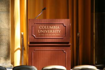 A podium with the Columbia University logo in a hall.