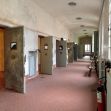 A hallway inside a youth correctional facility featuring multiple cell doors. A hallway inside a youth correctional facility featuring multiple cell doors.