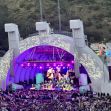 A vibrant concert scene at an amphitheater, featuring a colorful stage with performers and a large audience. A vibrant concert scene at an amphitheater, featuring a colorful stage with performers and a large audience.