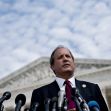 Texas Attorney General Ken Paxton speaks at a podium outside a government building, addressing issues related to abortion laws in Texas. Texas Attorney General Ken Paxton speaks at a podium outside a government building, addressing issues related to abortion laws in Texas.