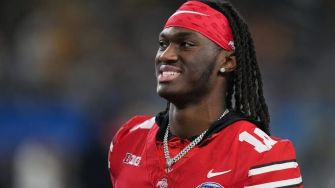 Marvin Harrison Jr. smiling while wearing a red football uniform and headband.