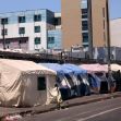 Tents set up along a city street, highlighting the issue of homelessness in California. Tents set up along a city street, highlighting the issue of homelessness in California.