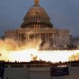 Crowds gather outside the Capitol building as smoke rises during the January 6 attack. Crowds gather outside the Capitol building as smoke rises during the January 6 attack.