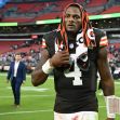 Cleveland Browns quarterback Deshaun Watson walking off the field during a game, wearing a towel on his head. Cleveland Browns quarterback Deshaun Watson walking off the field during a game, wearing a towel on his head.