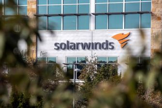 Logo and building of SolarWinds, a network-management software company, captured in an outdoor setting.