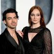 Sophie Turner and Joe Jonas posing together on the red carpet at an event. Sophie Turner and Joe Jonas posing together on the red carpet at an event.