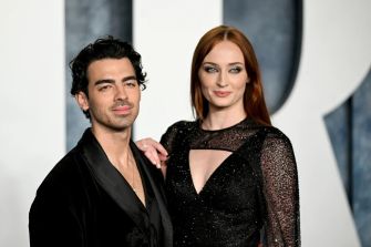 Sophie Turner and Joe Jonas posing together on the red carpet at an event.