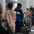 Travelers wait to check in to a flight inside the international terminal at San Francisco International Airport (SFO) in San Francisco, California, on Tuesday, May 11, 2021. David Paul Morris | Bloomberg | Getty Images