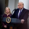 Former President Donald Trump speaking at a podium with the presidential seal, alongside a woman in a dark jacket, during a press event. Former President Donald Trump speaking at a podium with the presidential seal, alongside a woman in a dark jacket, during a press event.