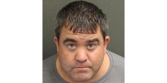Mugshot of a man arrested for attempted theft at Disney, wearing a gray shirt and with short hair.