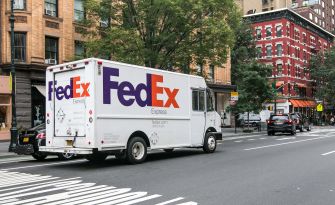 A FedEx delivery truck on a city street.
