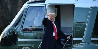 Former President Trump waves as he departs in a helicopter, marking the transition of power.