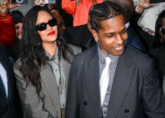 Rapper A$AP Rocky smiles as he exits the courtroom, accompanied by Rihanna, following his not guilty verdict on shooting charges.