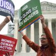 Demonstrators holding signs advocating for gun restrictions for domestic violence offenders outside the U.S. Supreme Court. Demonstrators holding signs advocating for gun restrictions for domestic violence offenders outside the U.S. Supreme Court.