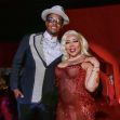 T.I. and Tiny Harris posing together at an event, dressed in stylish attire against a vibrant background. T.I. and Tiny Harris posing together at an event, dressed in stylish attire against a vibrant background.