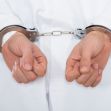 Hands in handcuffs, symbolizing legal consequences related to fraud. Hands in handcuffs, symbolizing legal consequences related to fraud.