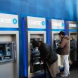 People using Chase bank ATMs. People using Chase bank ATMs.