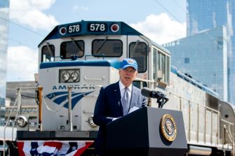 President Biden speaking at an Amtrak station, promoting his administration's infrastructure plan.