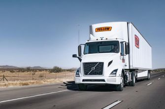 A freight truck operated by Yellow Transportation driving on a highway.