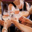 A group of women toasting with cocktails at a restaurant, highlighting social gatherings and promotions. A group of women toasting with cocktails at a restaurant, highlighting social gatherings and promotions.