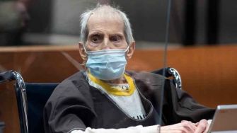 Robert Durst in court, wearing a mask and hospital gown, as he faces charges related to the murder of his first wife, Kathie Durst.