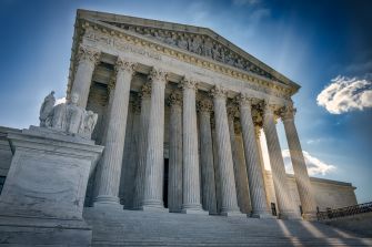 Image of the U.S. Supreme Court building with its iconic columns and statue in front.