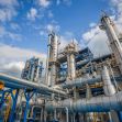 Chemical plant facility with industrial structures and pipes. Chemical plant facility with industrial structures and pipes.
