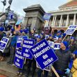 A group of educators holding signs in support of the Newton Teachers Association strike outside a government building. A group of educators holding signs in support of the Newton Teachers Association strike outside a government building.