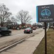 Welcome sign for the city of Evanston, Illinois, alongside a street with passing cars and bare trees. Welcome sign for the city of Evanston, Illinois, alongside a street with passing cars and bare trees.