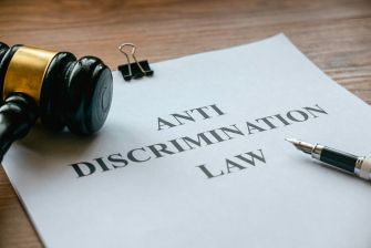 Document titled "ANTI DISCRIMINATION LAW" alongside a gavel and pen on a desk.