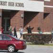 Students exit Forest High School with their hands raised in a precautionary response following a shooting incident. Students exit Forest High School with their hands raised in a precautionary response following a shooting incident.