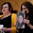 A woman holding a framed photo of a victim speaks during a press conference about the historic $73 million settlement with gun maker Remington. A woman holding a framed photo of a victim speaks during a press conference about the historic $73 million settlement with gun maker Remington.