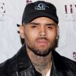 Image of Chris Brown at an event, wearing a black hat and jacket. Image of Chris Brown at an event, wearing a black hat and jacket.