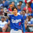 A baseball player in a blue Dodgers uniform waving to the crowd during a game. A baseball player in a blue Dodgers uniform waving to the crowd during a game.