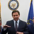 A press conference featuring Florida Governor Ron DeSantis speaking about cruise ship regulations, surrounded by officials. A press conference featuring Florida Governor Ron DeSantis speaking about cruise ship regulations, surrounded by officials.