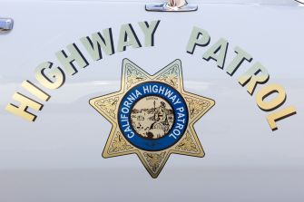 California Highway Patrol badge displayed on a patrol vehicle.