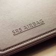 Close-up of an SRS airbag label on a vehicle's interior. Close-up of an SRS airbag label on a vehicle's interior.
