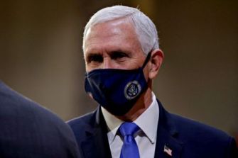 Mike Pence wearing a mask during a formal event.