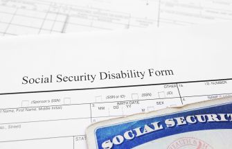 Social Security disability form with a Social Security card in the foreground.