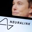 Logo of Neuralink with a blurred figure in the background. Logo of Neuralink with a blurred figure in the background.