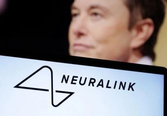 Logo of Neuralink with a blurred figure in the background.