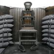 An execution chair surrounded by sandbags, used in firing squad executions. An execution chair surrounded by sandbags, used in firing squad executions.