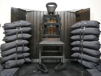 An execution chair surrounded by sandbags, used in firing squad executions.